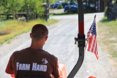 Farmhand driving the tractor at Great Country Farms