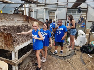 School children fill their peat pots in the greenhouse for planting sunflowers during a field trip at Great Country Farms in Northern Virginia.