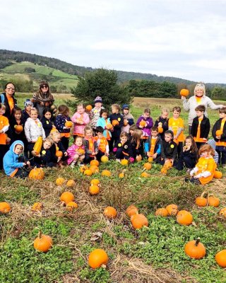 Field Trip students proudly display their pumpkins they picked on their school tour at Great Country Farms.