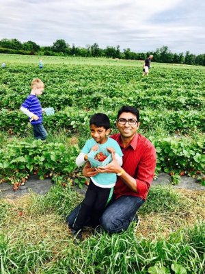 Guests pose for a photo in the "better and organic " pick your own strawberry patch at Great Country Farms in northern Virginia.