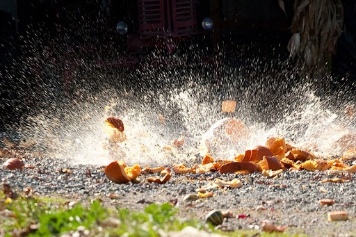 a pumpkin explodes in a giant splash as it hits the ground after being dropped from a 40 foot lift at Great Country Farms' Pumpkin Chunking Event