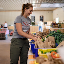 Anna Hall, Great Country Farms CSA Manager, checks the supplies of pack your own CSA product in the farm market.