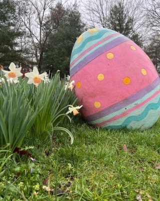 a giant Easter egg and daffodills in bloom make a great photo op for families visiting the Great Country Farms Easter Egg Hunt