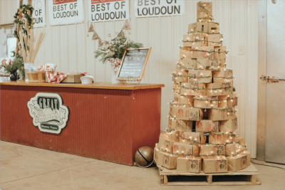 Christmas Market Main image. Christmas tree made of apple cider boxes next to a checkout counter